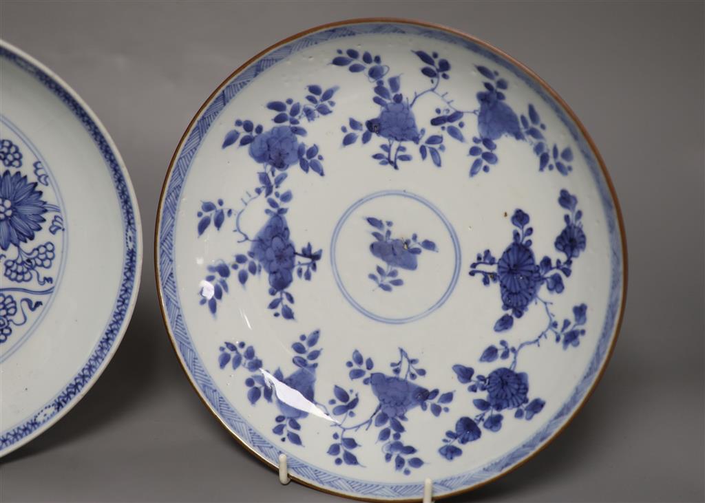 Two Chinese Kangxi blue and white dishes, one with Batavia cafe-au-lait glaze to the underside, diameter 22cm